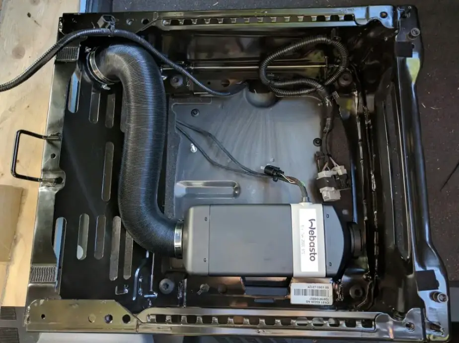 A Webasto heater unit mounted under a vehicle seat base